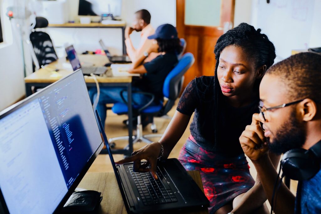 woman with man at computer a black owned enterprise for a Black Business Month post