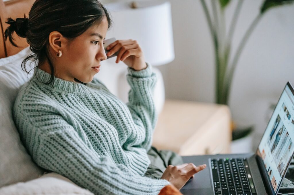 photo of a young woman on her laptop in in blog article about the importance of employers taking care of their employees in order to survive post pandemic shortage