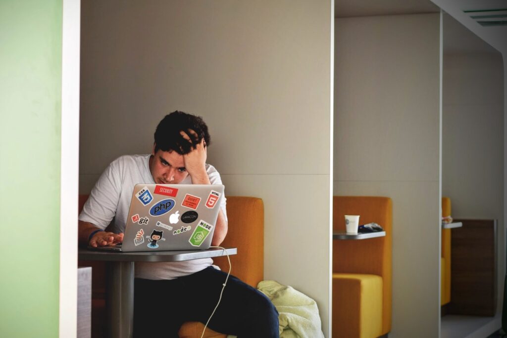 Photo of a man sitting in bench looking stressed in in blog article about the importance of employers taking care of their employees in order to survive post pandemic shortage